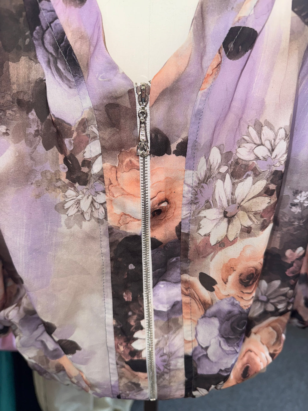 Floral frill neck zip fastening long sleeved top